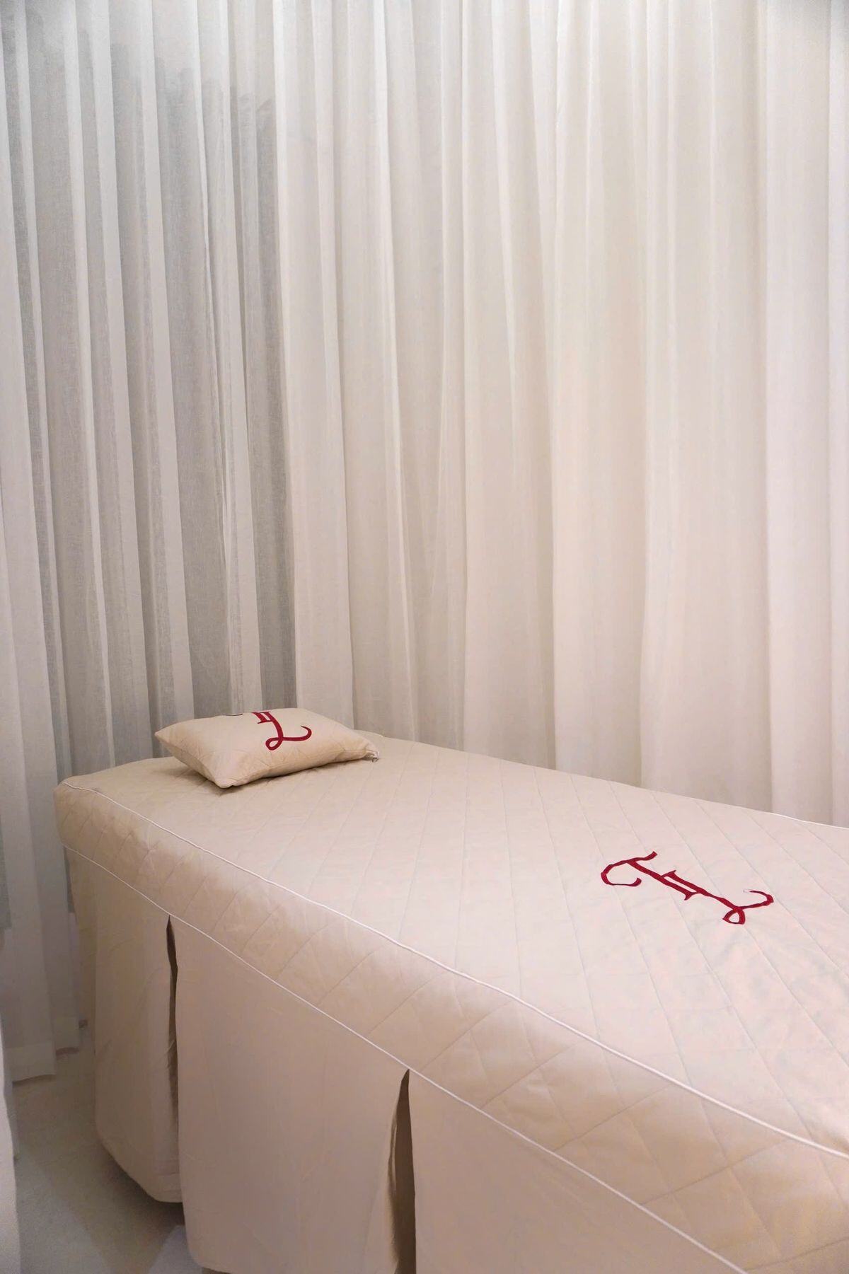 Quiet massage room with a prepared treatment bed and soft natural light