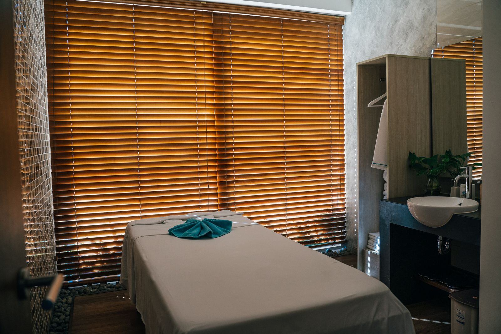 Clean, quiet private massage room prepared with fresh linens