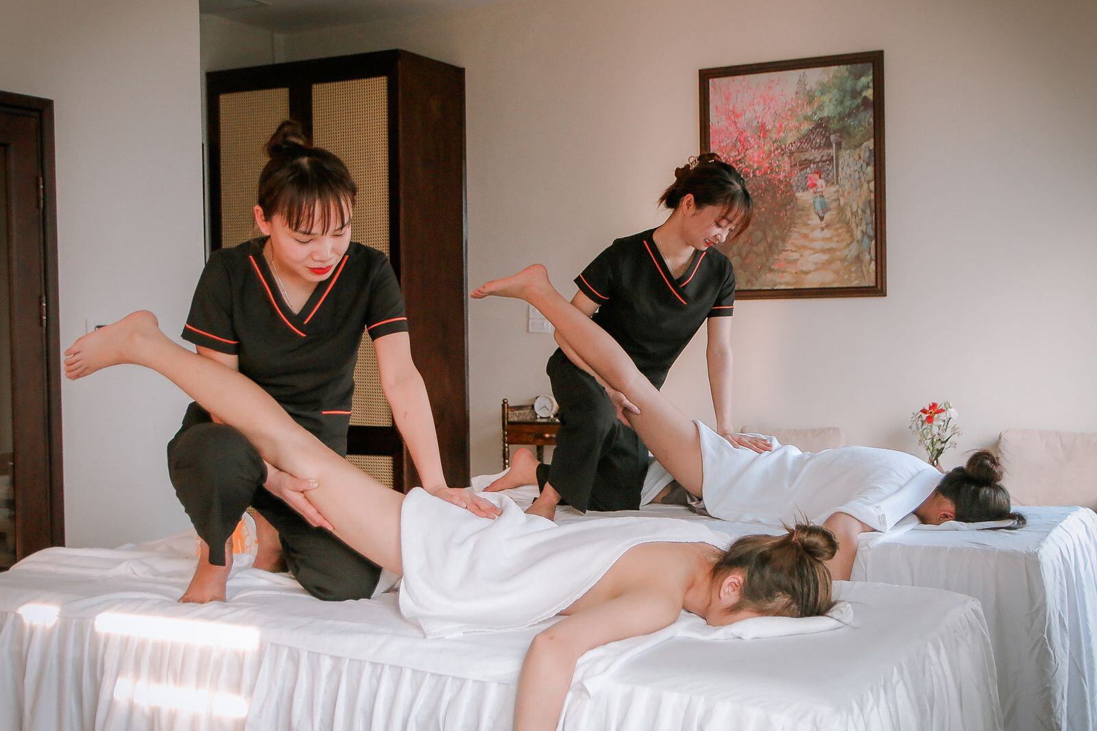 Therapists using assisted stretching during a combination massage session